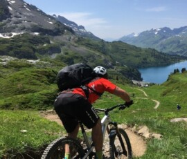 man in black jacket riding on mountain bike during daytime