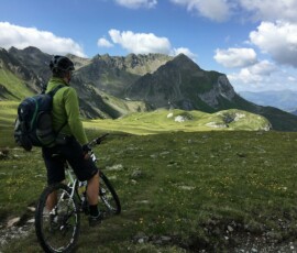 man riding bicycle on top of mountain